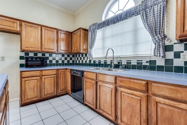 kitchen featuring brown cabinetry, black dishwasher, a sink, and wallpapered walls