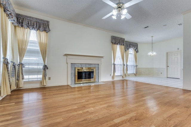 unfurnished living room with wood finished floors and a wealth of natural light