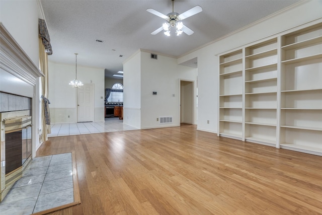 unfurnished living room featuring light wood-type flooring, visible vents, crown molding, and ceiling fan with notable chandelier