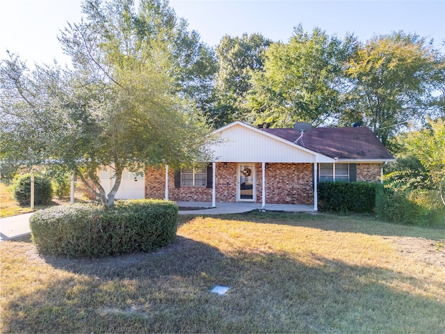 single story home featuring a front lawn, brick siding, and an attached garage