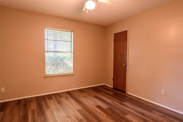 unfurnished room featuring ceiling fan, a textured ceiling, baseboards, and wood finished floors