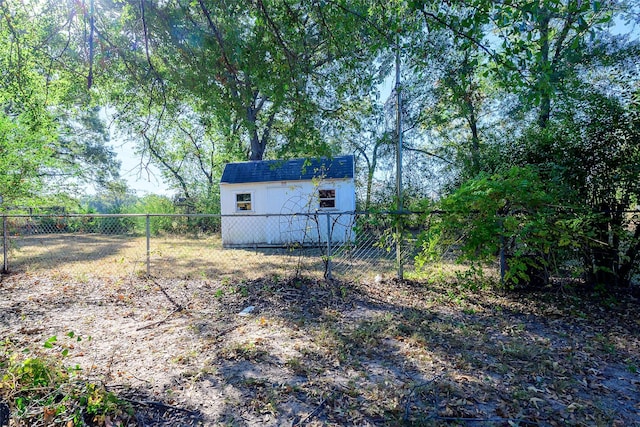 view of yard with a storage unit, an outdoor structure, and a fenced backyard