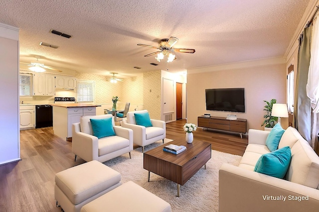 living area featuring ceiling fan, light wood-style flooring, and wallpapered walls