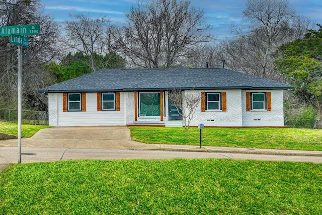 single story home featuring a front lawn, crawl space, a shingled roof, and brick siding