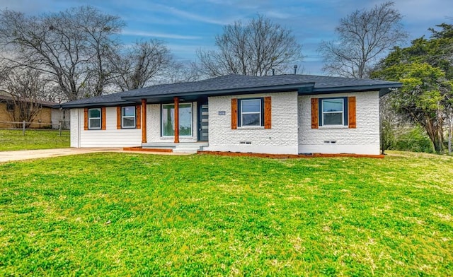 ranch-style home featuring crawl space, driveway, a front yard, and brick siding