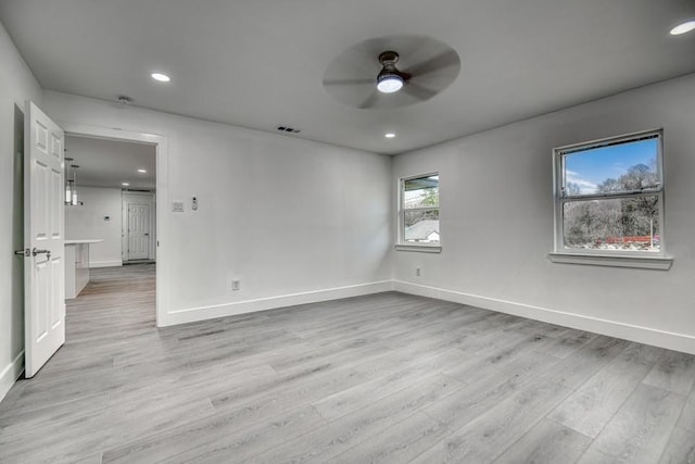 unfurnished room with light wood finished floors, baseboards, visible vents, a ceiling fan, and recessed lighting