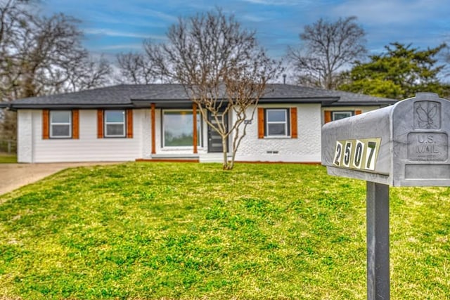 single story home with a front lawn and crawl space