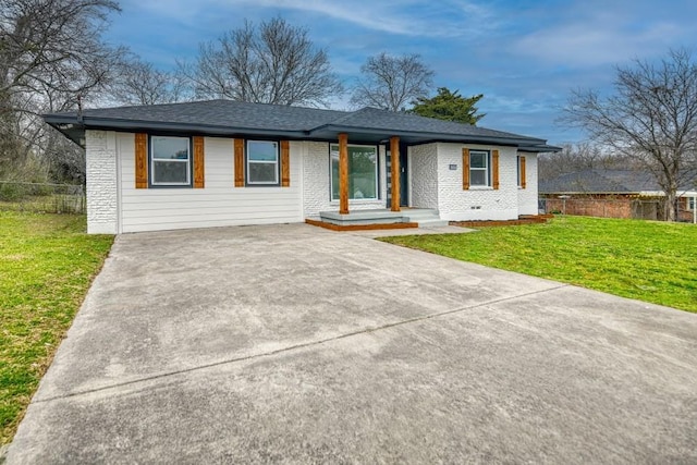 view of front of property featuring crawl space, brick siding, fence, and a front lawn