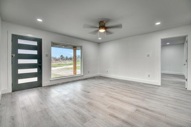 interior space featuring ceiling fan, baseboards, light wood-style flooring, and recessed lighting