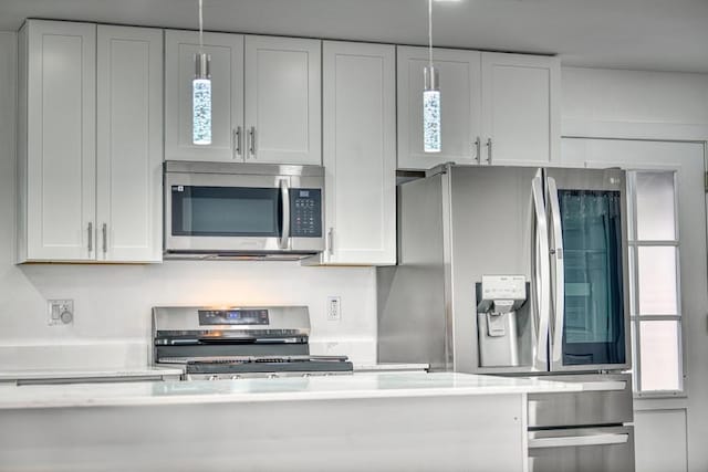 kitchen with stainless steel appliances, white cabinets, and light countertops