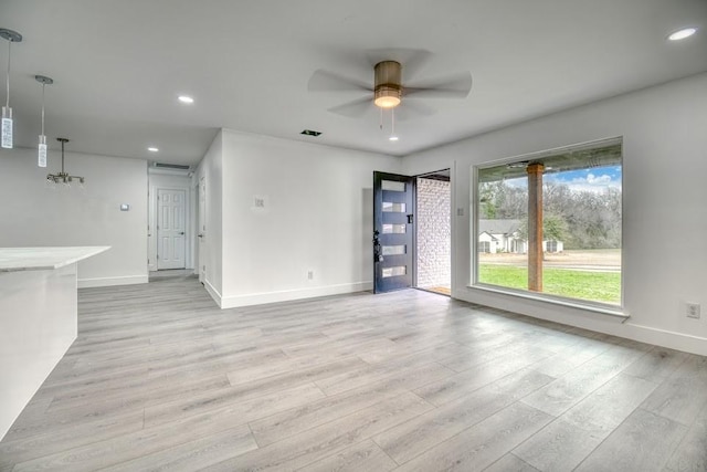 unfurnished living room featuring ceiling fan, light wood finished floors, baseboards, and recessed lighting