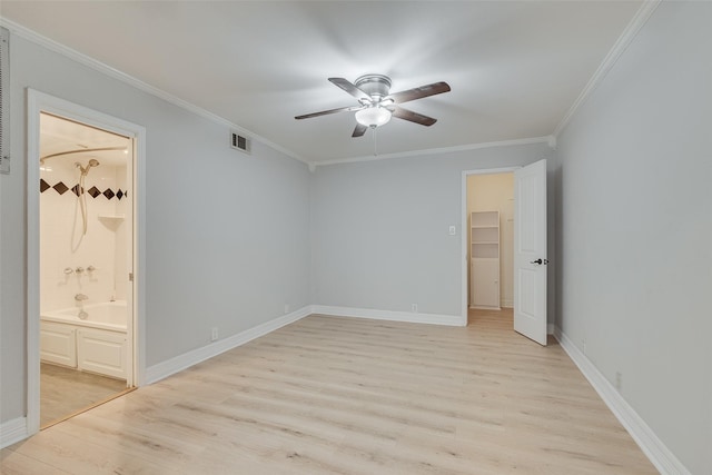 empty room featuring light wood finished floors, baseboards, visible vents, a ceiling fan, and crown molding