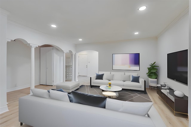 living area with decorative columns, arched walkways, light wood-style flooring, ornamental molding, and recessed lighting