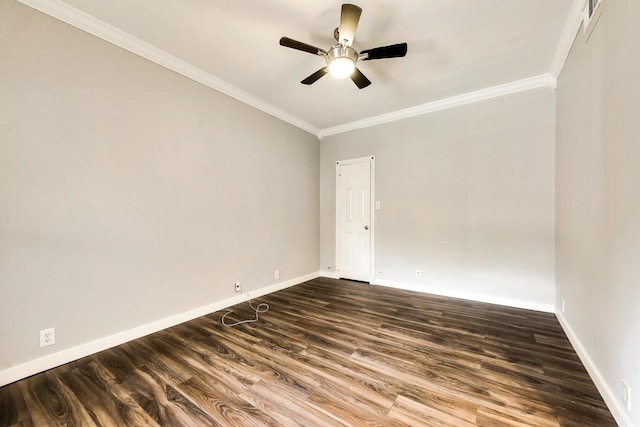 spare room with crown molding, dark wood-type flooring, a ceiling fan, and baseboards