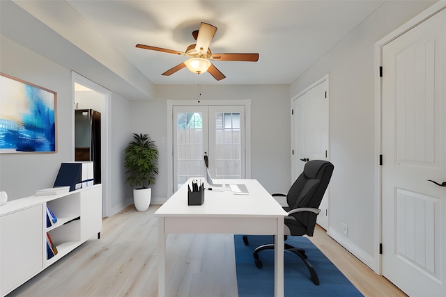 office featuring light wood-style flooring, baseboards, ceiling fan, and french doors