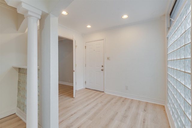 spare room with light wood-style floors, baseboards, ornamental molding, and recessed lighting