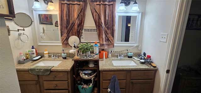 bathroom with two vanities, a sink, and a textured wall