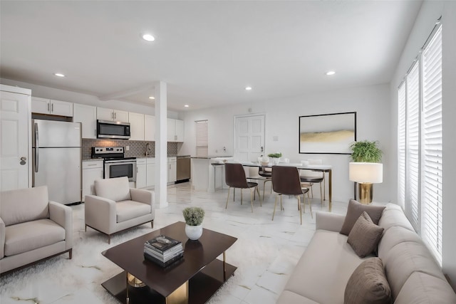 living room featuring marble finish floor and recessed lighting