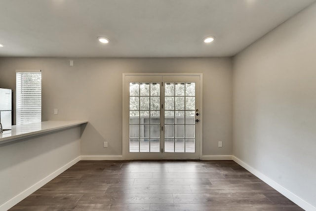 interior space with recessed lighting, dark wood finished floors, and baseboards