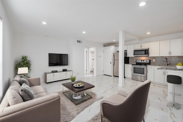 living room featuring marble finish floor, visible vents, and recessed lighting