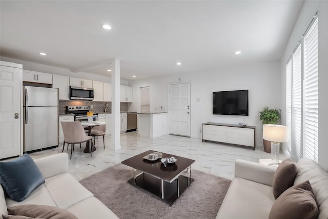 living area featuring marble finish floor and recessed lighting