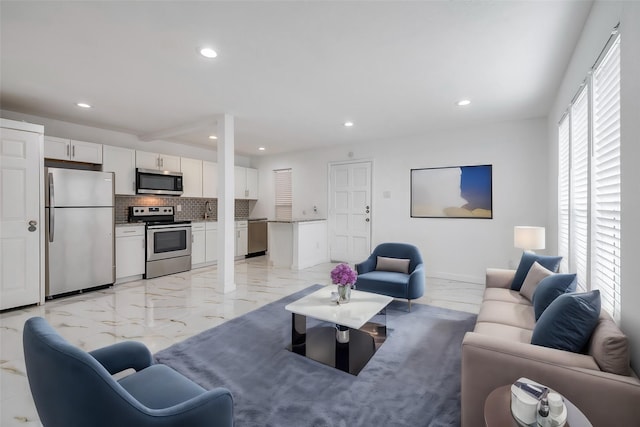 living area with marble finish floor and recessed lighting