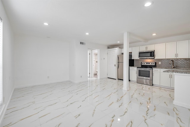 kitchen with tasteful backsplash, visible vents, baseboards, appliances with stainless steel finishes, and marble finish floor