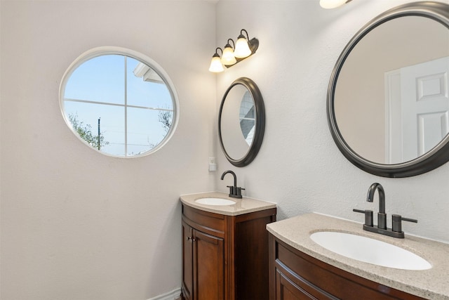 bathroom with two vanities and a sink