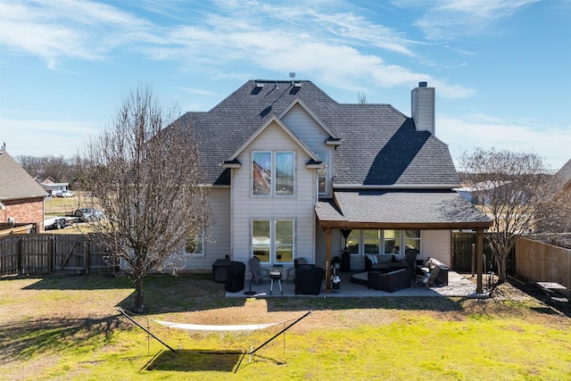 back of property featuring a fenced backyard, a shingled roof, a patio area, a lawn, and an outdoor hangout area