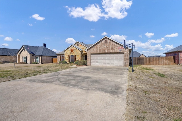 view of front of property featuring concrete driveway, brick siding, an attached garage, and fence