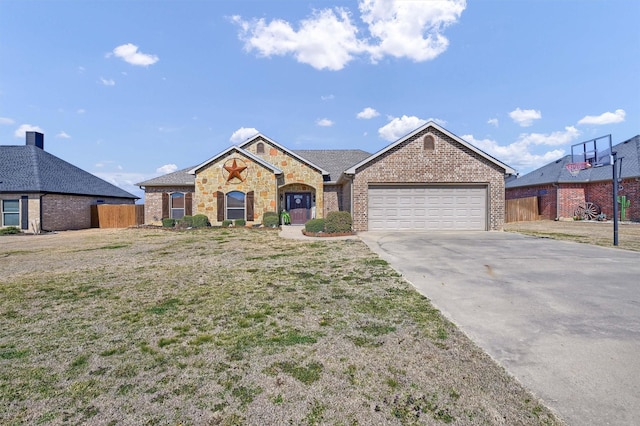 single story home featuring brick siding, fence, driveway, and an attached garage