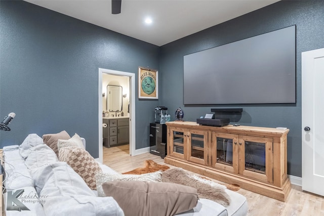 cinema room with baseboards and wood finished floors