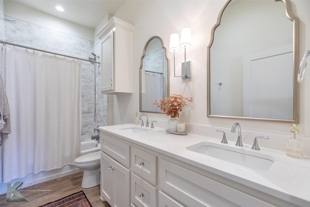 full bath featuring toilet, shower / bath combo, a sink, and wood finished floors