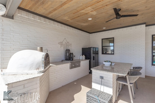 view of patio / terrace featuring ceiling fan and an outdoor kitchen