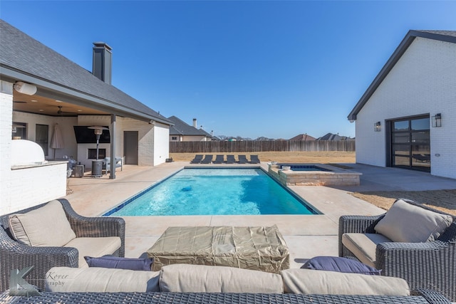 view of pool featuring a patio area, a fenced backyard, a pool with connected hot tub, and an outdoor hangout area