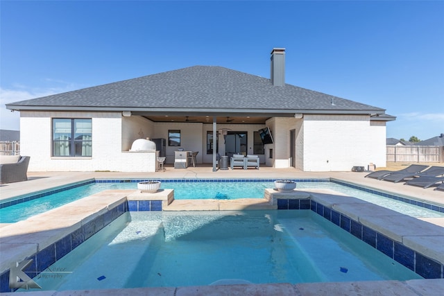 view of swimming pool with ceiling fan, a patio, fence, an outdoor living space, and a pool with connected hot tub