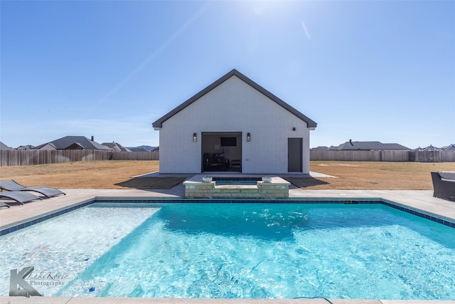 view of pool with an outbuilding, a fenced backyard, and a fenced in pool