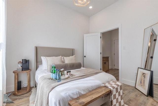 bedroom with recessed lighting, light wood-style flooring, and baseboards