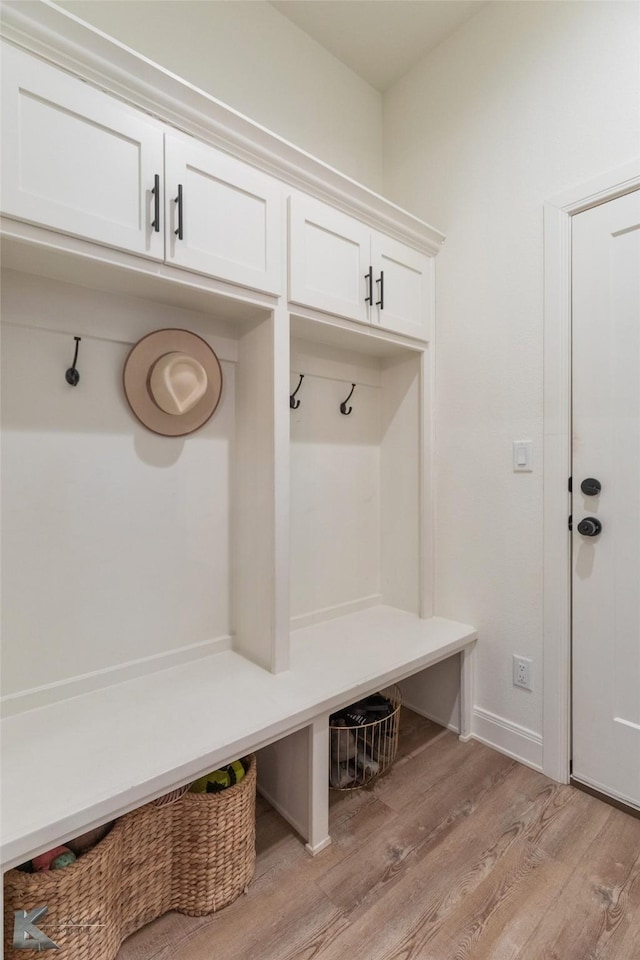 mudroom featuring light wood-style flooring and baseboards