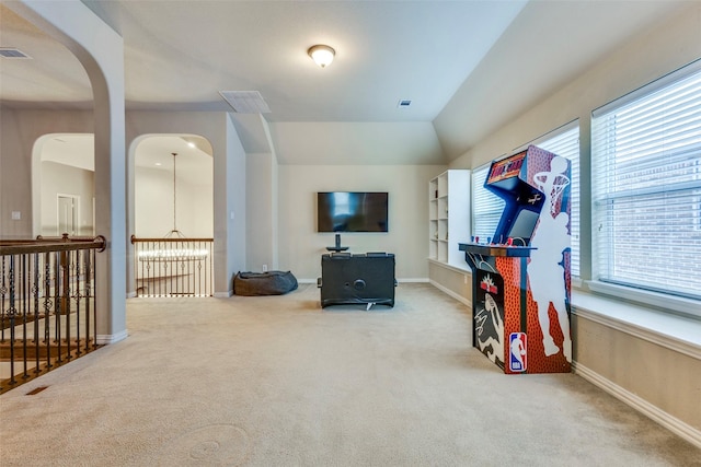 workout area featuring carpet floors, baseboards, visible vents, and lofted ceiling