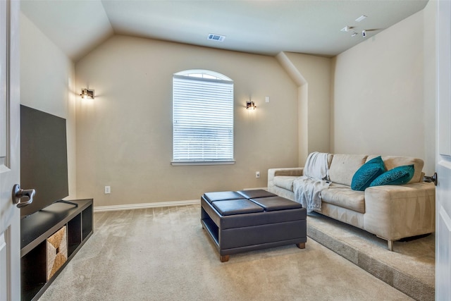 carpeted living area featuring lofted ceiling, visible vents, and baseboards