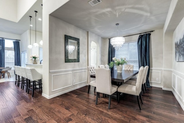 dining room with visible vents, plenty of natural light, and wood finished floors