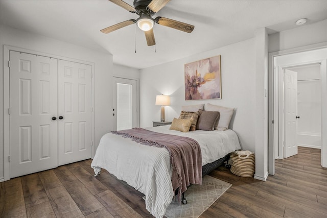 bedroom featuring a ceiling fan, a closet, baseboards, and wood finished floors