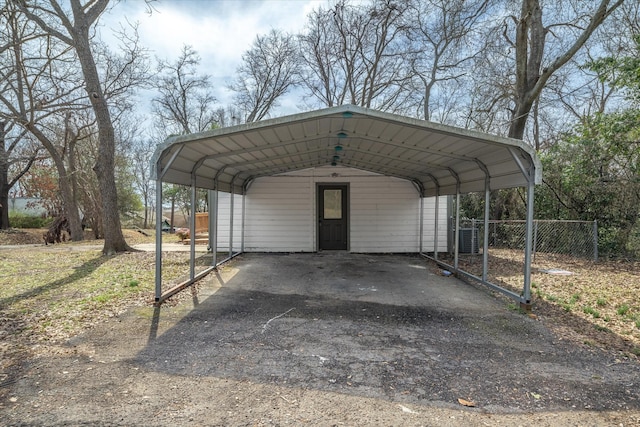 view of parking featuring aphalt driveway and a detached carport