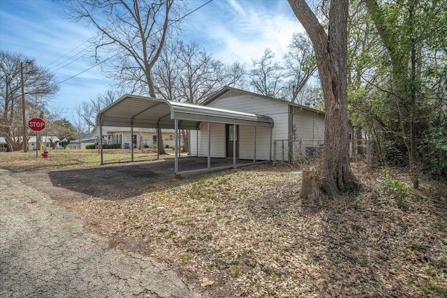 view of front of home featuring a detached carport and driveway