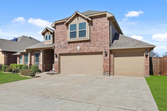 view of front of house featuring brick siding, a shingled roof, fence, and a front yard