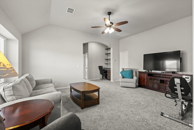 carpeted living area featuring arched walkways, lofted ceiling, visible vents, a ceiling fan, and baseboards