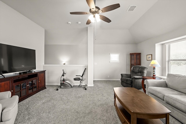 carpeted living room with lofted ceiling, baseboards, visible vents, and a ceiling fan