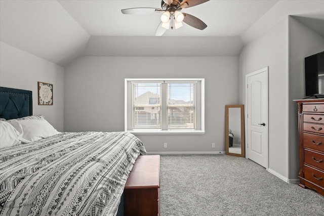 carpeted bedroom with vaulted ceiling, ceiling fan, and baseboards