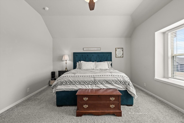 carpeted bedroom with lofted ceiling, ceiling fan, and baseboards